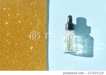 Serum gel texture swatch. Transparent drop with golden sparkles. Serum gel texture swatch. Transparent drop with golden sparkles. 117325119