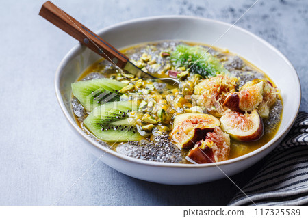 Chia pudding with tropical fruits - kiwi figs, passion fruit and pistachio. Chia pudding with tropical fruits - kiwi figs, passion fruit and pistachio. 117325589