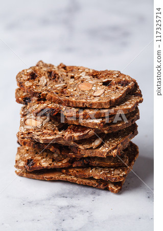 Healthy nuts and seed bread on white marble background. Healthy nuts and seed bread on white marble background. 117325714