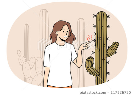 Stressed woman touching cactus plant in desert 117326730