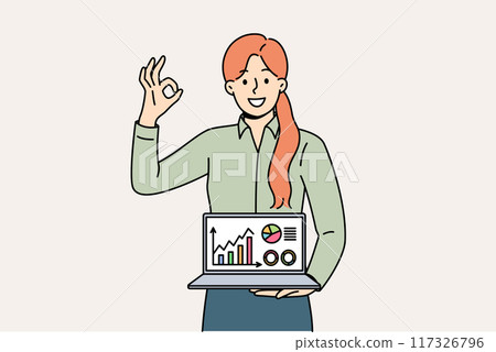 Business woman shows laptop with diagrams and ok gesture, reporting success of startup 117326796