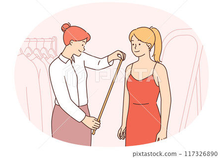 Seamstress measure client in atelier 117326890