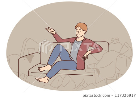 Man sit on sofa surrounded with trash 117326917