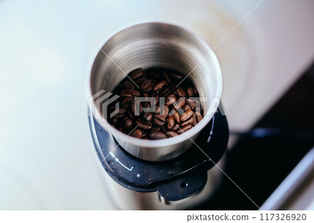 Beans in a coffee grinder 117326920
