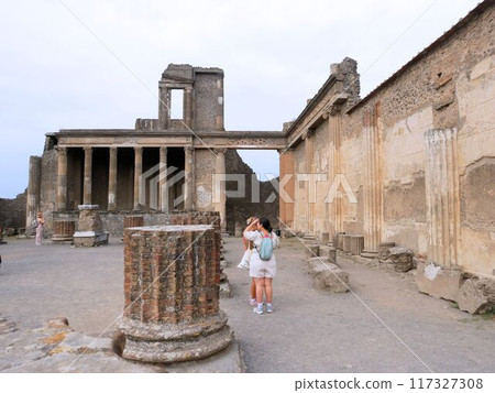 Tourists looking at the ruins of Pompeii, Italy Tourists looking at the ruins of Pompeii, Italy 117327308