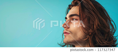 Young Man with Long Hair Gazing Upwards 117327347