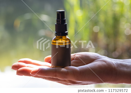 Hand Holding Cosmetic Product Mockup Hand Holding Cosmetic Product Mockup 117329572