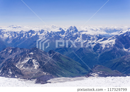 mountain landscape, view from highland snow slope to green valleys, view from Mount Elbrus to the Main Caucasian Range mountain landscape, view from highland snow slope to green valleys, view from Mount Elbrus to the Main Caucasian Range 117329799