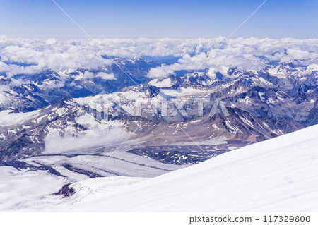 mountain landscape, view from highland glacier to mountain ranges in the clouds, view from the Mount Elbrus to the Main Caucasian Range mountain landscape, view from highland glacier to mountain ranges in the clouds, view from the Mount Elbrus to the Main Caucasian Range 117329800