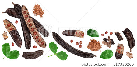 Ripe carob pods and bean isolated on white background. Top view with copy space for your text. Flat lay Ripe carob pods and bean isolated on white background. Top view with copy space for your text. Flat lay 117330269