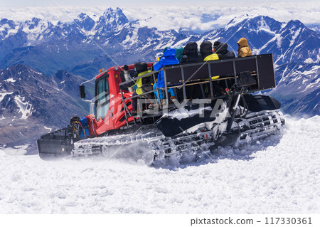 transporting climbers by snowcat when climbing Mount Elbrus 117330361