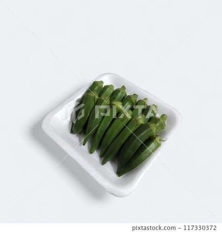 fresh okra pods on white background, vibrant green colour, inviting texture. crisp & delicious, perfect for culinary creations. 117330372