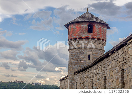 Tower of the Old Kamenets-Podolsk fortress against the background of the sky with clouds, Ukraine. 117332266