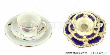 Vintage porcelain cups and saucer isolated on white. Free space for text. Wide photo. Collage. Vintage porcelain cups and saucer isolated on white. Free space for text. Wide photo. Collage. 117332509