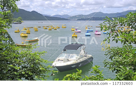 Yellow, white recreational outdoor boats, mountain, lake and sky 117332603