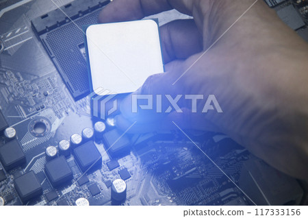 Top view of technician installing CPU chip on motherboard, CPU chip It's the brain part of the computer. 117333156
