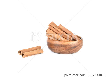 Dry cassia spice sticks in bowl and on white background. Dry cassia spice sticks in bowl and on white background. 117334008