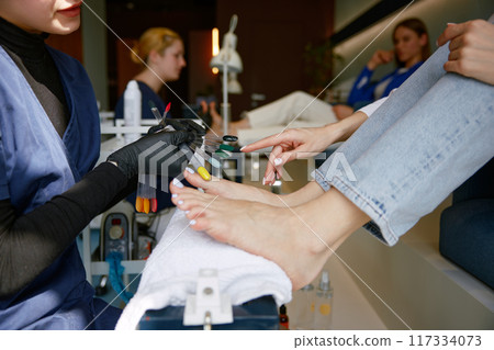 View from above on client choosing color for nail during pedicure View from above on client choosing color for nail during pedicure 117334073