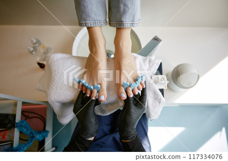 Closeup above view of preparation for painting nails on foot Closeup above view of preparation for painting nails on foot 117334076