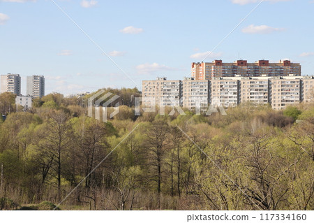 View of the residential area of the city with colored multi storey buildings standing on a hillside View of the residential area of the city with colored multi storey buildings standing on a hillside 117334160