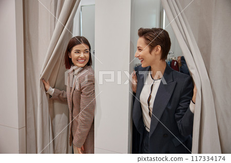 Happy young girlfriends in fitting room in clothing department store 117334174