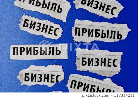 Newspaper clippings with the words business and profit in Russian, Cyrillic, blue background. Newspaper clippings with the words business and profit in Russian, Cyrillic, blue background. 117334231