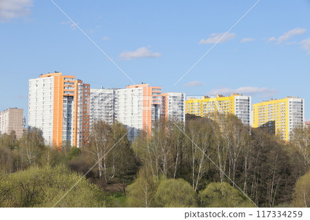 View of the residential area of the city with colored multi-storey buildings standing on a hillside View of the residential area of the city with colored multi-storey buildings standing on a hillside 117334259