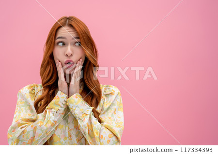Long-haired pretty ginger woman looking astonished and looking aside 117334393