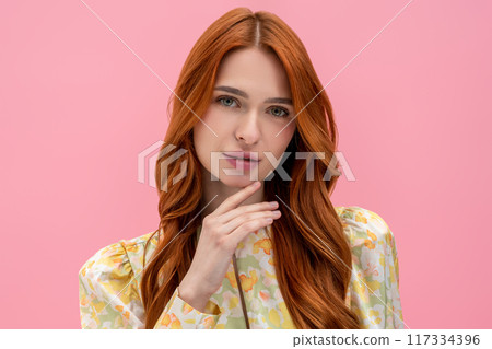 Ginger long-haired young woman looking relaxed and peaceful 117334396