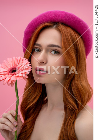 Dreamy cute young woman with a flower 117334429