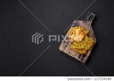 Vegetable zucchini fritters with garlic, salt, spices and herbs 117334580