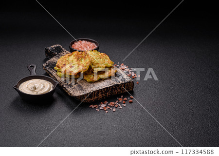 Vegetable zucchini fritters with garlic, salt, spices and herbs 117334588