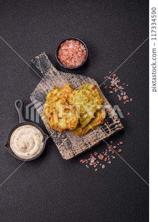 Vegetable zucchini fritters with garlic, salt, spices and herbs 117334590