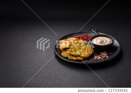 Vegetable zucchini fritters with garlic, salt, spices and herbs 117334591