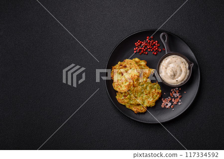 Vegetable zucchini fritters with garlic, salt, spices and herbs 117334592