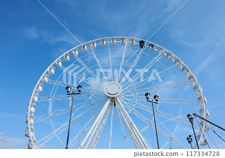 Ferris wheel against the blue sky. Ferris wheel against the blue sky. 117334728