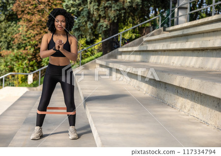 Woman exercising outdoors and looking concentrated and focused 117334794
