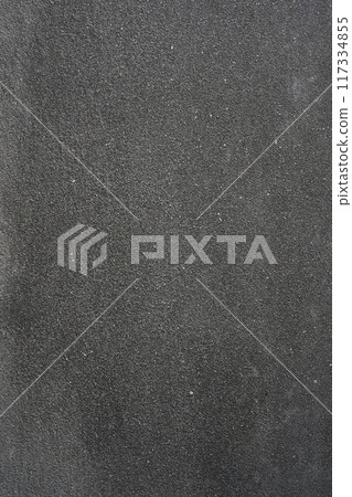 A dark grey concrete wall textured background. Vertical photo. Close-up, texture and detail, granular, hard, rough surface. Free space for copying. Industrial backdrop. 117334855