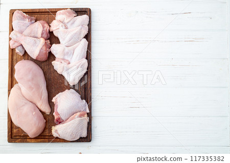 Raw mixed chicken meat parts  for cooking on rustic background 117335382