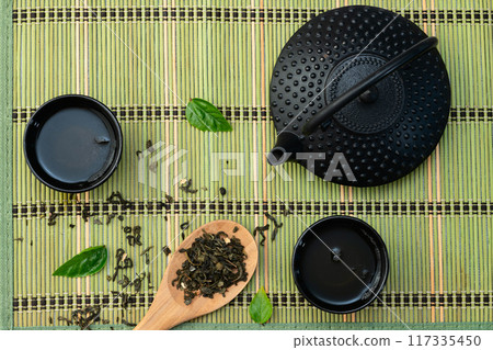 Green Tea with japanese teapot and leaves Green Tea with japanese teapot and leaves 117335450