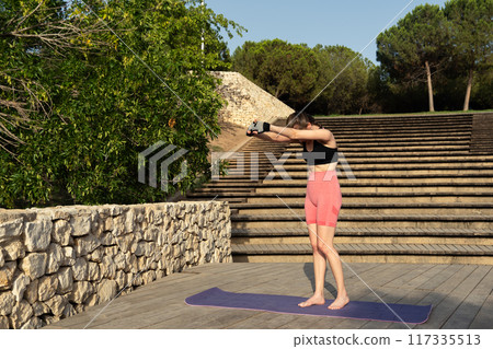 a yoga teacher doing stretches 117335513