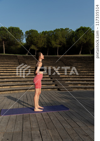a redhead yoga teacher doing stretches 117335514