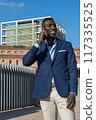 young businessman on the phone laughing 117335525