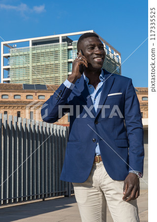 young businessman on the phone laughing young businessman on the phone laughing 117335525