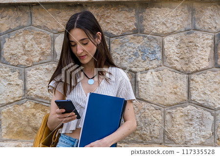 young woman with folder an a smartphone 117335528