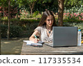 girl with laptop in park 117335534