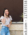 young woman talking on the phone 117335538