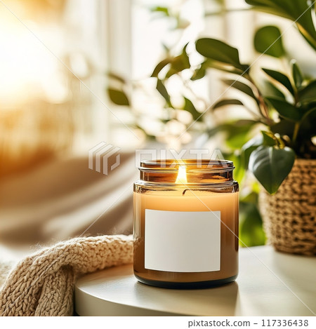 Candle jar mockup, burning candle mockup with white label, scented candle template in cozy home interior 117336438