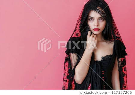 Young woman in halloween costume with red eyes and lips, long dark hair, wearing a black corset with lace on pink background with copy space Young woman in halloween costume with red eyes and lips, long dark hair, wearing a black corset with lace on pink background with copy space 117337266