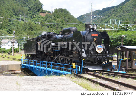 Steam locomotive C61 turning around on a turntable Steam locomotive C61 turning around on a turntable 117339777